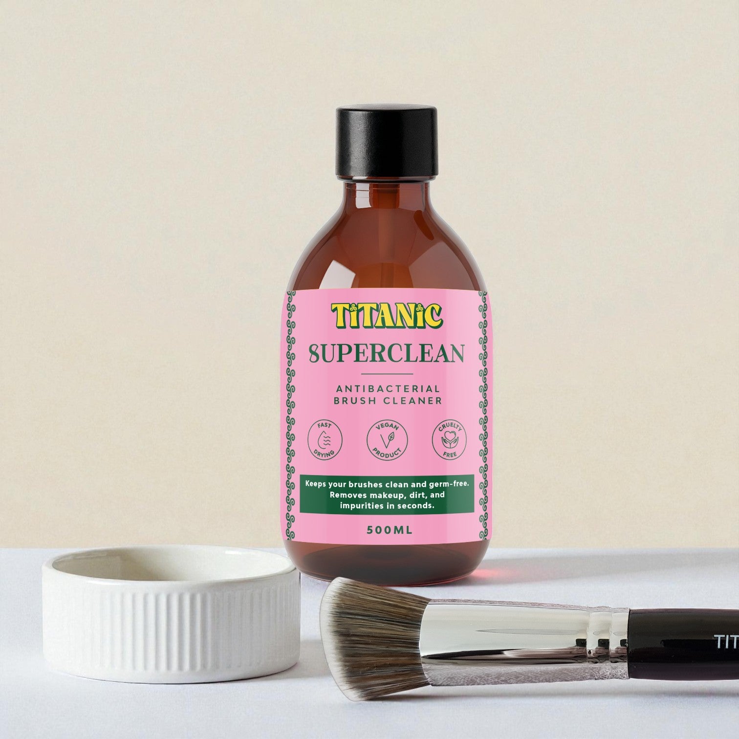 Bottle of Titanic Superclean antibacterial brush cleaner with a brush and container on a light background